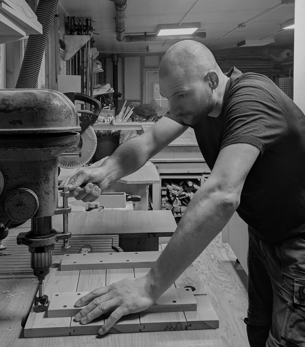 Shaker kitchen Joshua howard building a kitchen in his Yorkshire workshop. He he is photographed drilling doors for a Blum soft close hinge